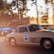 A screenshot of some cars driving down the road.